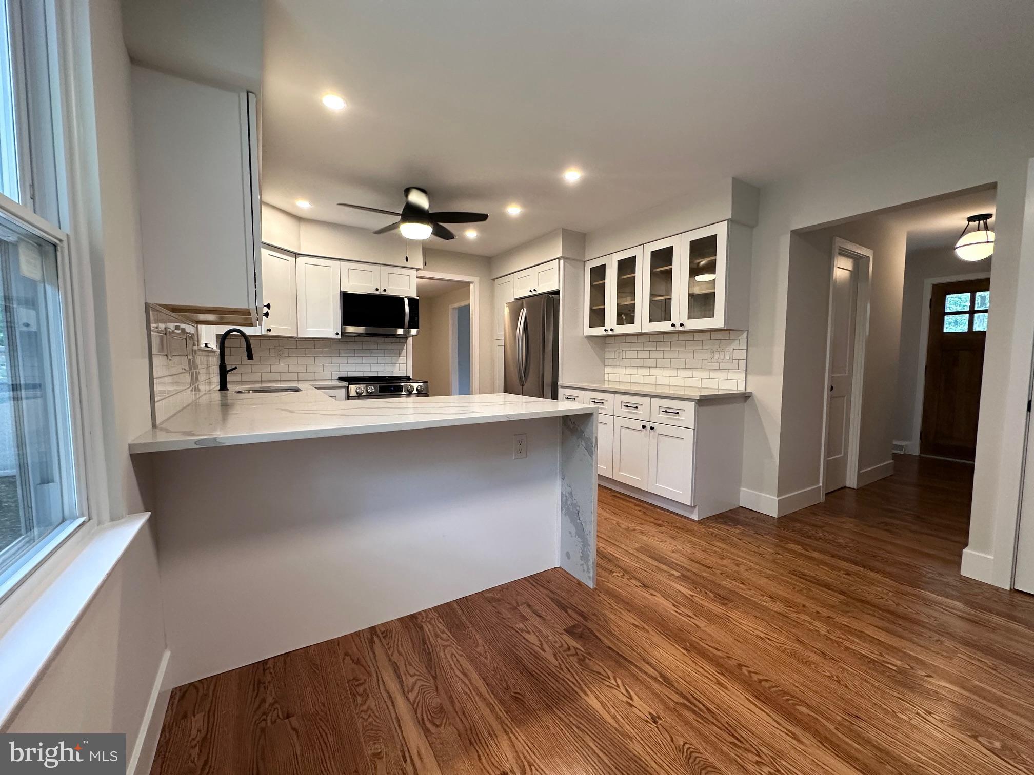 215 Bridge Road Upper Chichester, PA 19061 - Photo 13 of 35 a kitchen with kitchen island cabinets and wooden floor