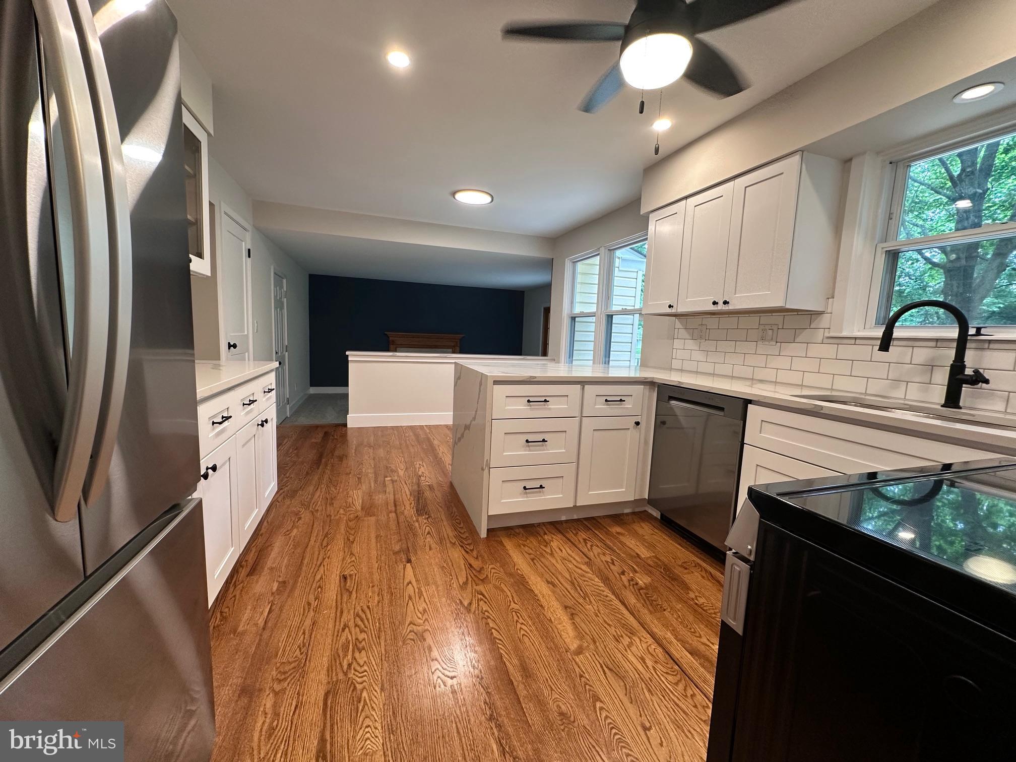 215 Bridge Road Upper Chichester, PA 19061 - Photo 15 of 35 a kitchen with stainless steel appliances a refrigerator sink and wooden floor