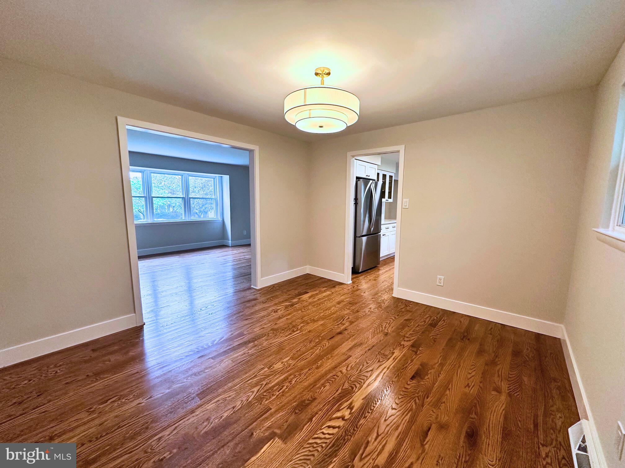 215 Bridge Road Upper Chichester, PA 19061 - Photo 18 of 35 an empty room with wooden floor and windows