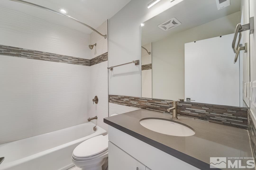 100 High Street, Unit 100 Reno, NV 89502 - Photo 15 of 20 a bathroom with a granite countertop sink toilet and shower
