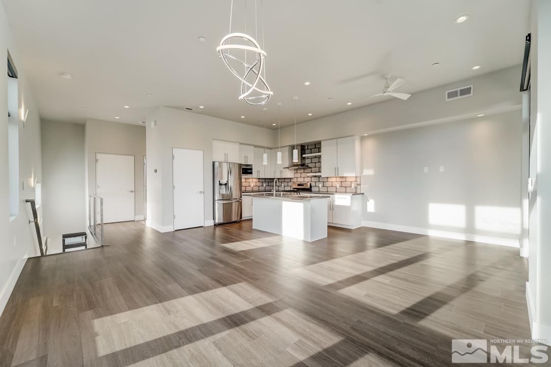 100 High Street, Unit 100 Reno, NV 89502 - Photo 6 of 20 a view of kitchen with cabinets and wooden floor