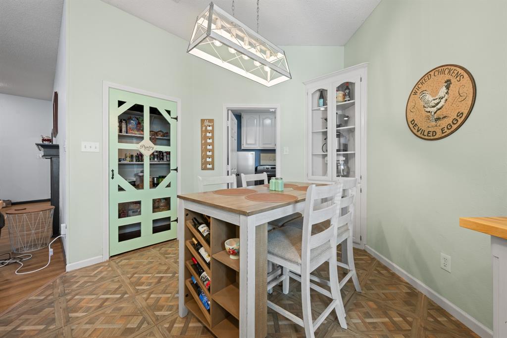 905 Evandale Road Burleson, TX 76028 - Photo 19 of 40 a view of a kitchen with a table and a chair