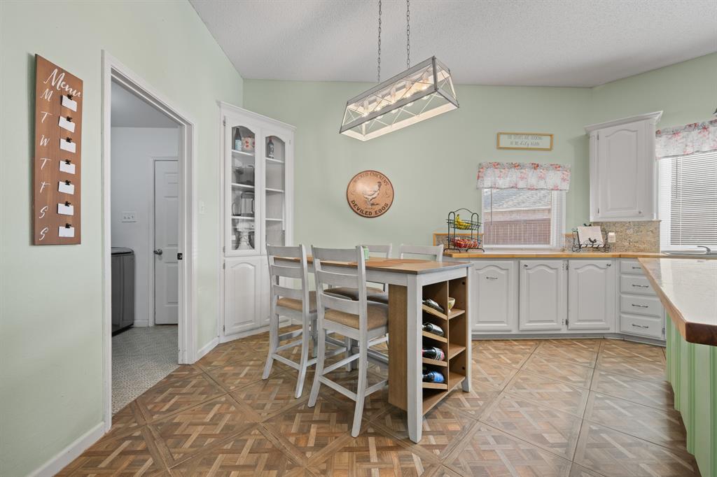 905 Evandale Road Burleson, TX 76028 - Photo 20 of 40 a kitchen with a table and chairs in it