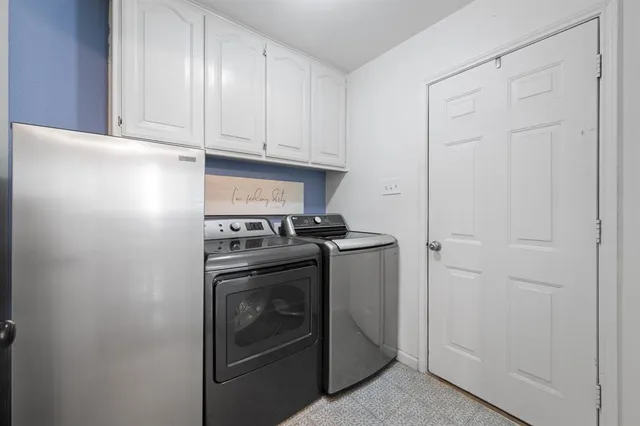a view of a storage and utility room with washer and dryer