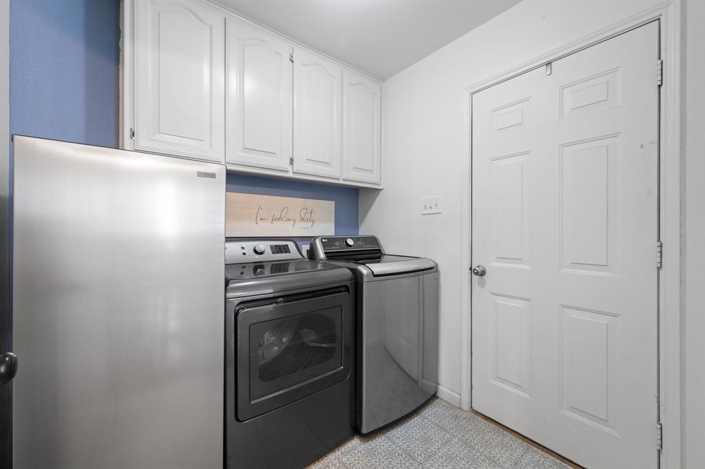 905 Evandale Road Burleson, TX 76028 - Photo 21 of 40 a view of a storage and utility room with washer and dryer