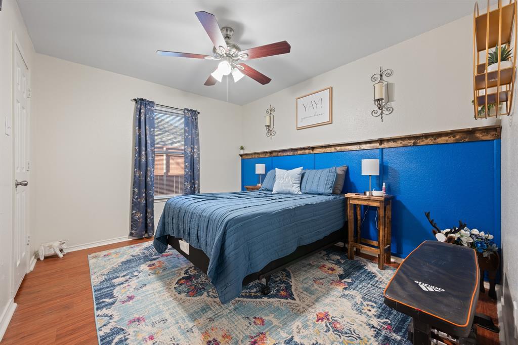 905 Evandale Road Burleson, TX 76028 - Photo 25 of 40 a bedroom with a bed and a chandelier