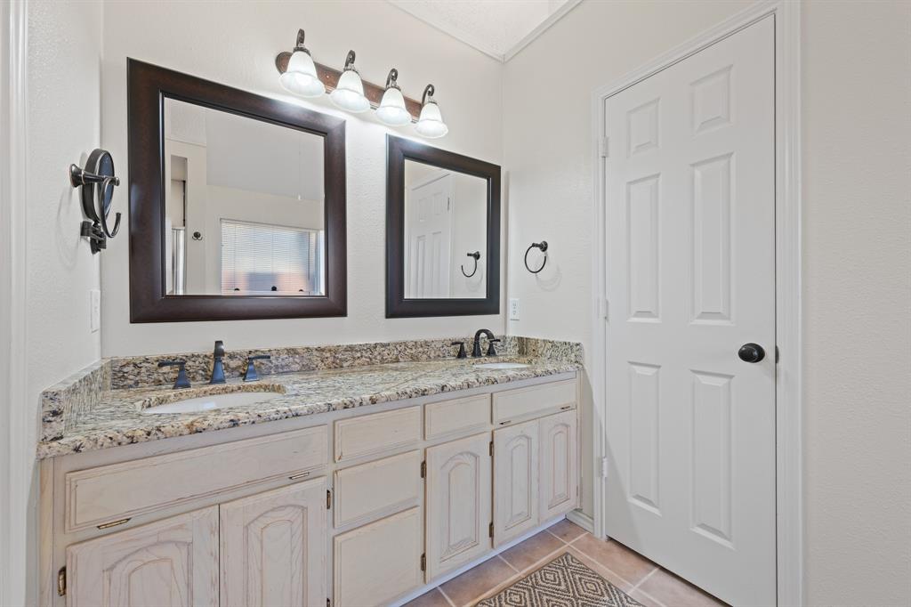 905 Evandale Road Burleson, TX 76028 - Photo 30 of 40 a bathroom with a double vanity sink and a mirror