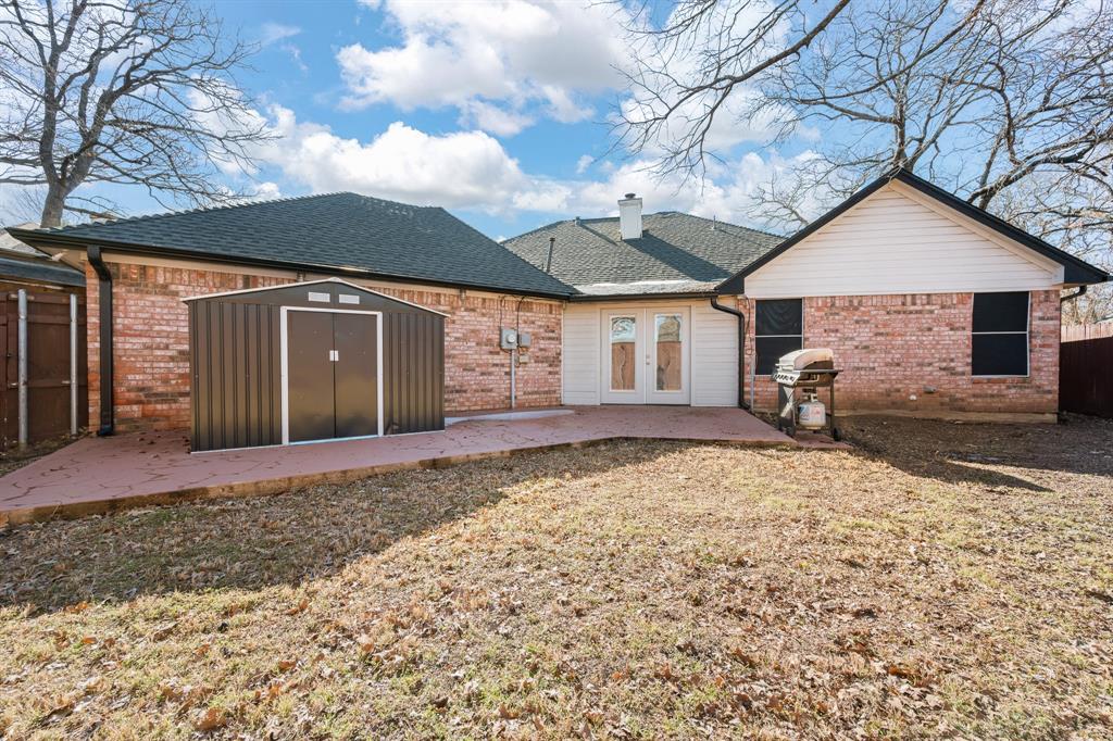 905 Evandale Road Burleson, TX 76028 - Photo 36 of 40 a front view of a house with a yard and garage