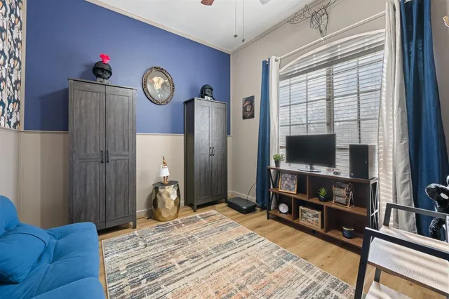 a bedroom with furniture and a flat screen tv