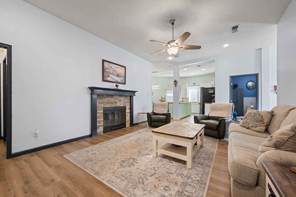 905 Evandale Road Burleson, TX 76028 - Photo 10 of 40 a living room with furniture and a fireplace