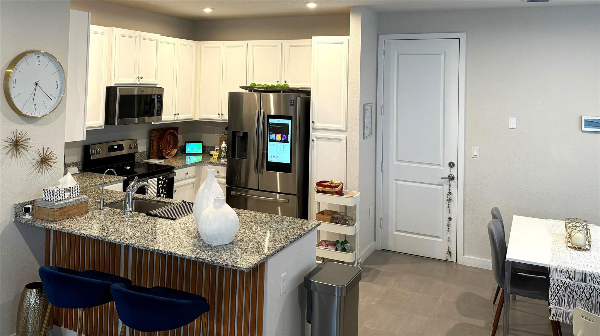 10957 Southwest 232nd Terrace Homestead, FL 33032 - Photo 2 of 11 a kitchen with stainless steel appliances granite countertop a stove a refrigerator a microwave a sink and cabinets