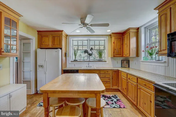 a kitchen with a stove a sink and a refrigerator