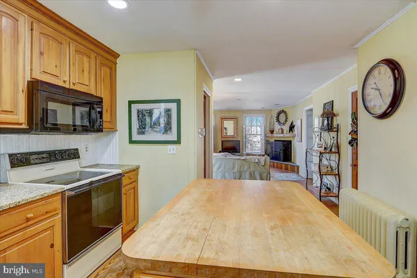 a kitchen with stainless steel appliances granite countertop a stove and a refrigerator