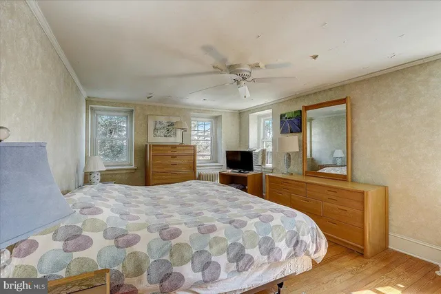 a bedroom with a large bed and a chandelier