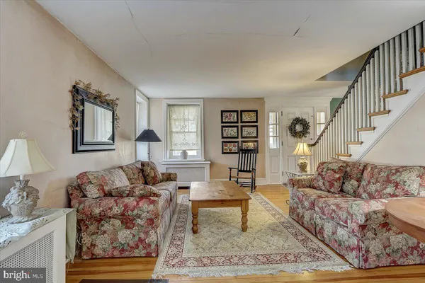 a living room with furniture a rug and a table