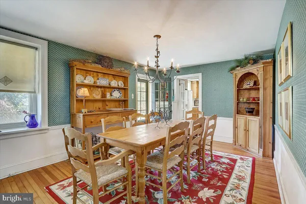 a dining room with furniture a rug and wooden floor