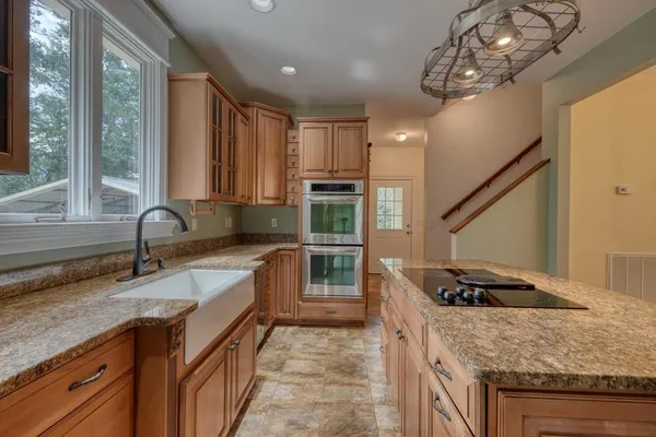 a kitchen with granite countertop a stove and a sink