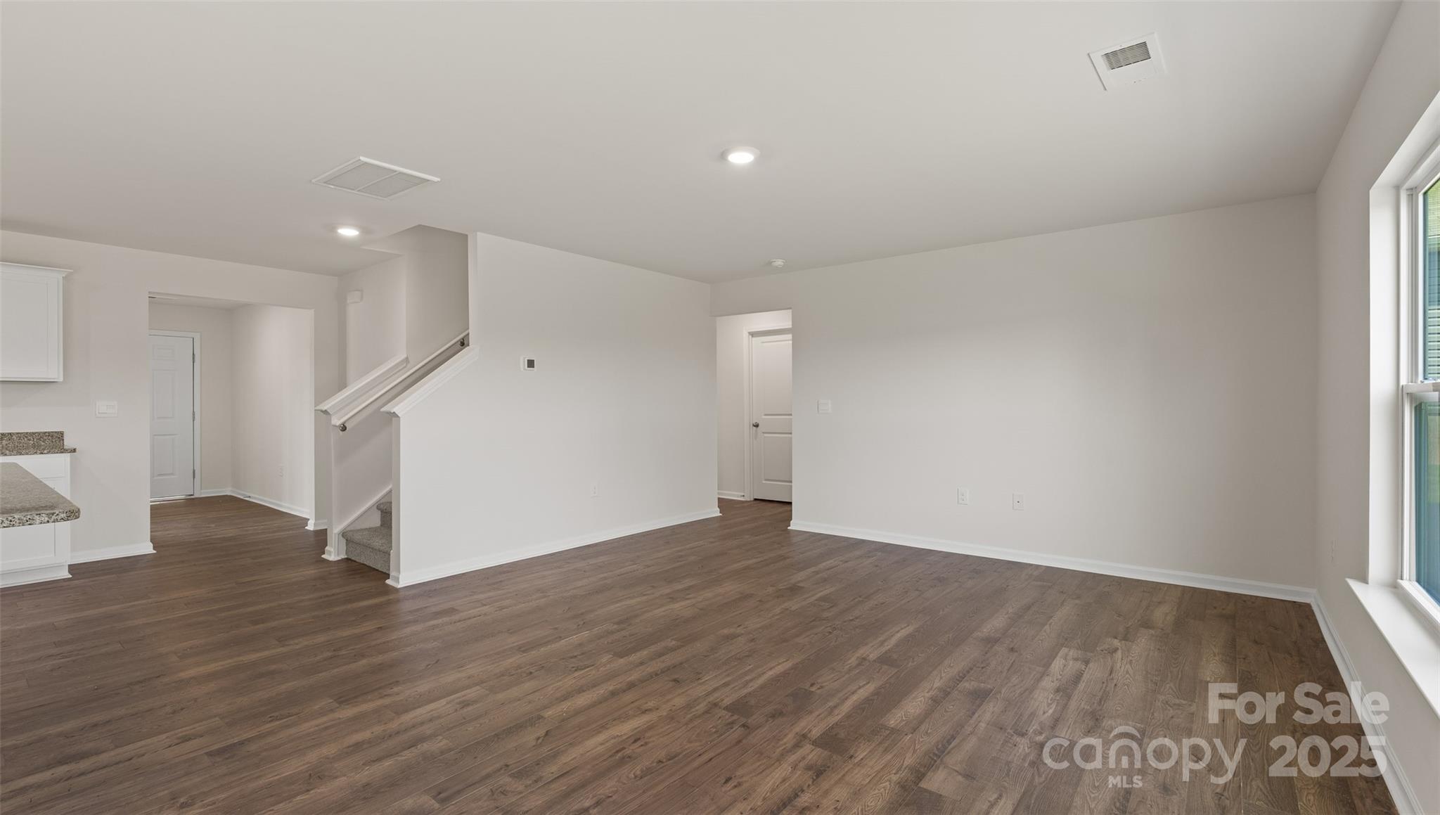 155 Callie River Clyde, NC 28721 - Photo 14 of 29 wooden floor in an empty room with a window