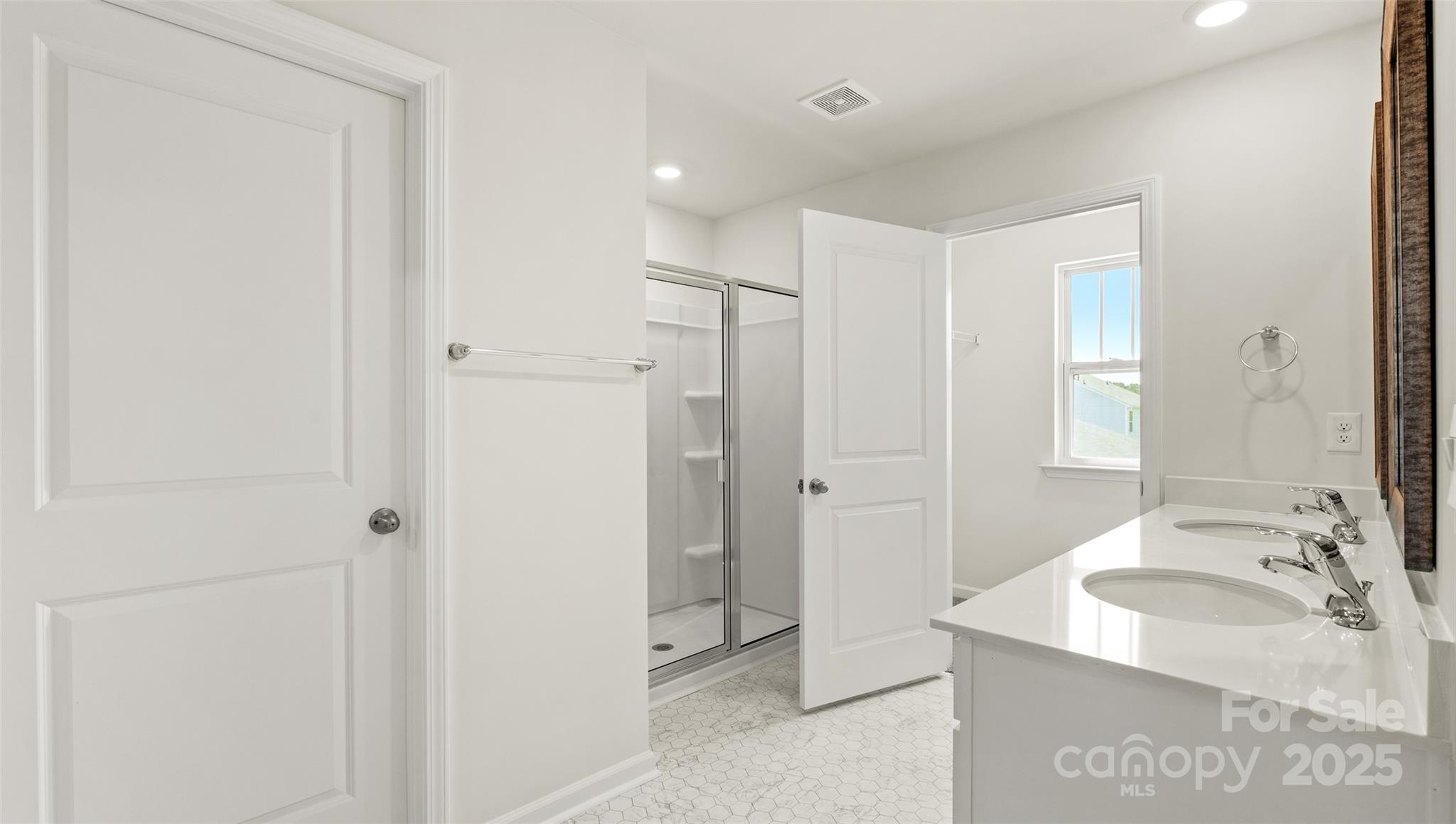 155 Callie River Clyde, NC 28721 - Photo 23 of 29 a bathroom with a granite countertop sink a mirror and a shower