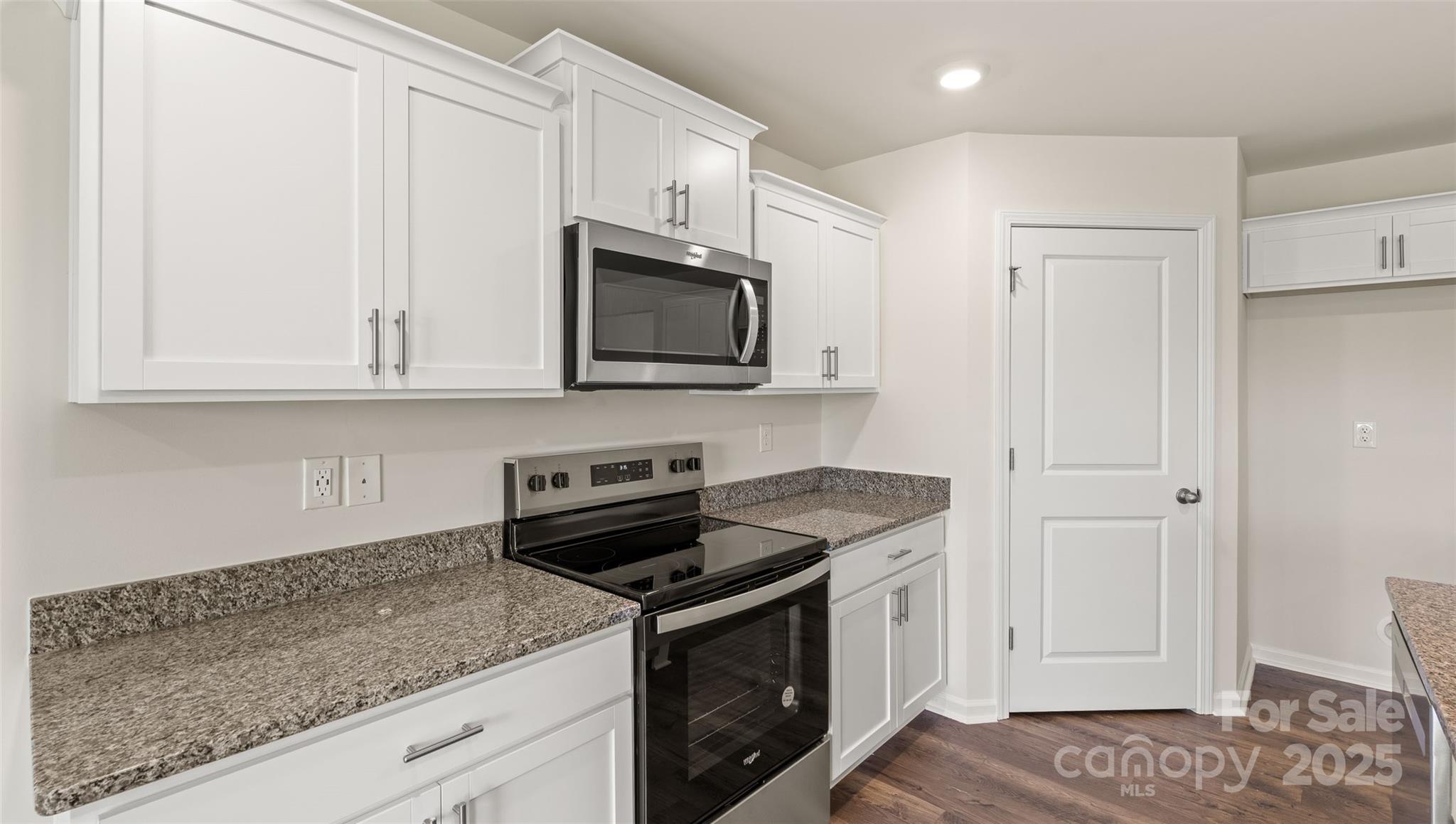 155 Callie River Clyde, NC 28721 - Photo 7 of 29 a kitchen with stainless steel appliances granite countertop white cabinets and a stove