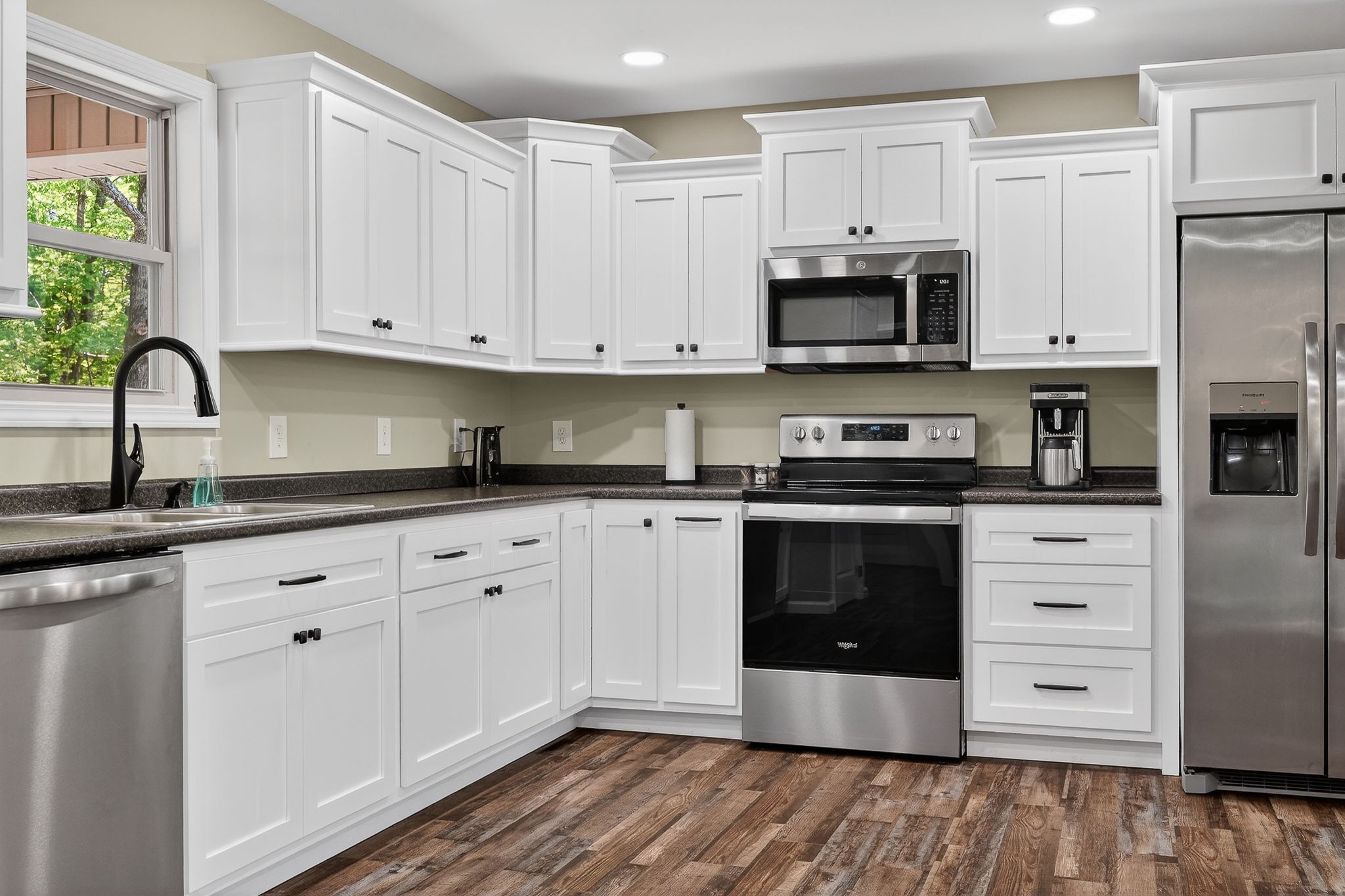 2110 Windle Community Road Cookeville, TN 38506 - Photo 16 of 35 a kitchen with stainless steel appliances granite countertop a stove a sink and a microwave