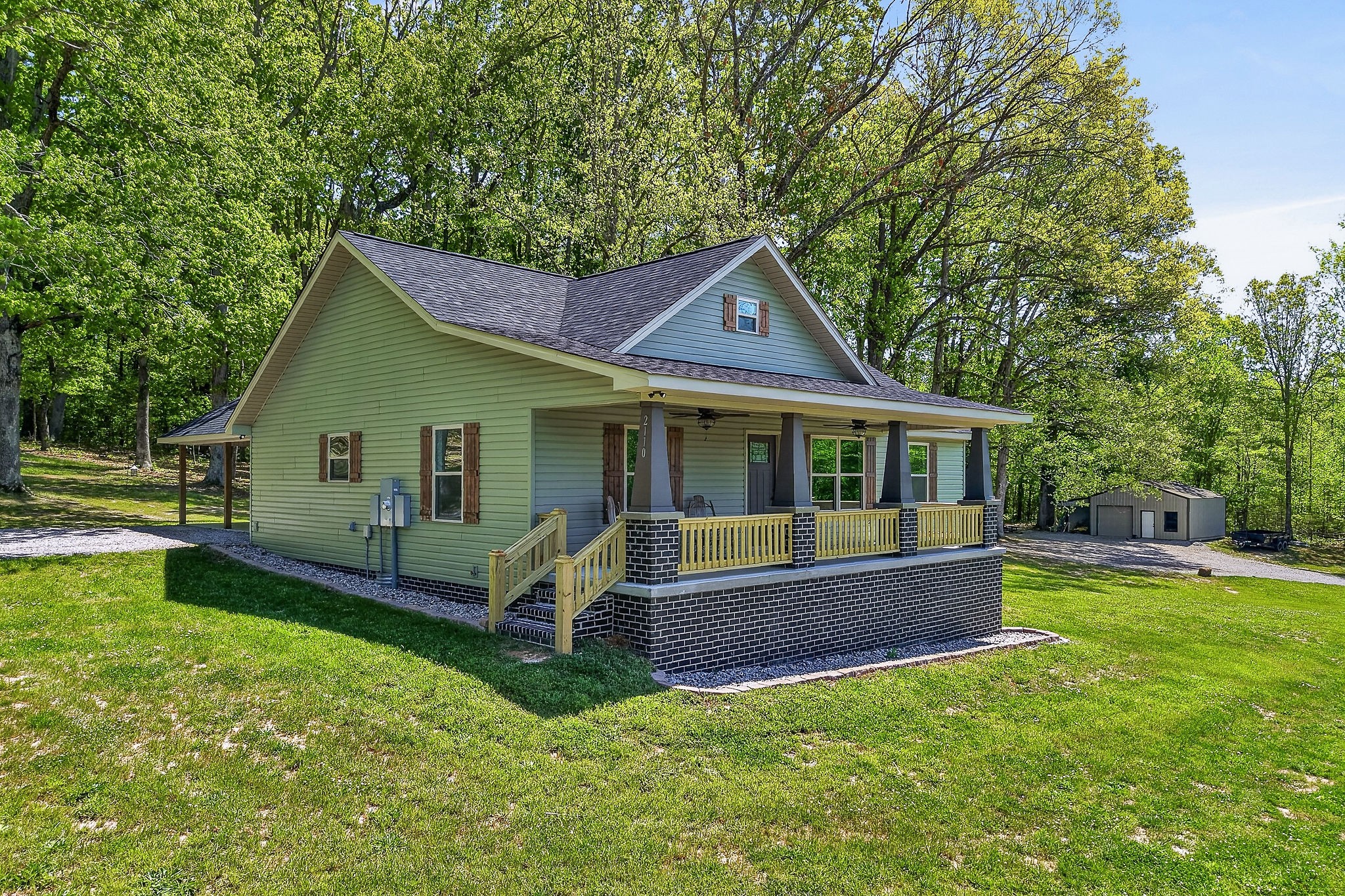 2110 Windle Community Road Cookeville, TN 38506 - Photo 2 of 35 a front view of a house with a yard table and chairs