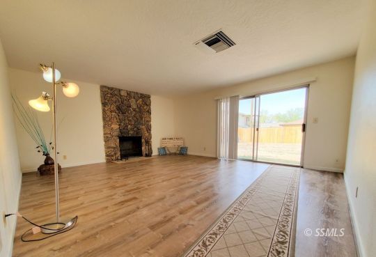 732 West Alene Avenue Ridgecrest, CA 93555 - Photo 20 of 38 a view of an empty room with a fireplace and a window