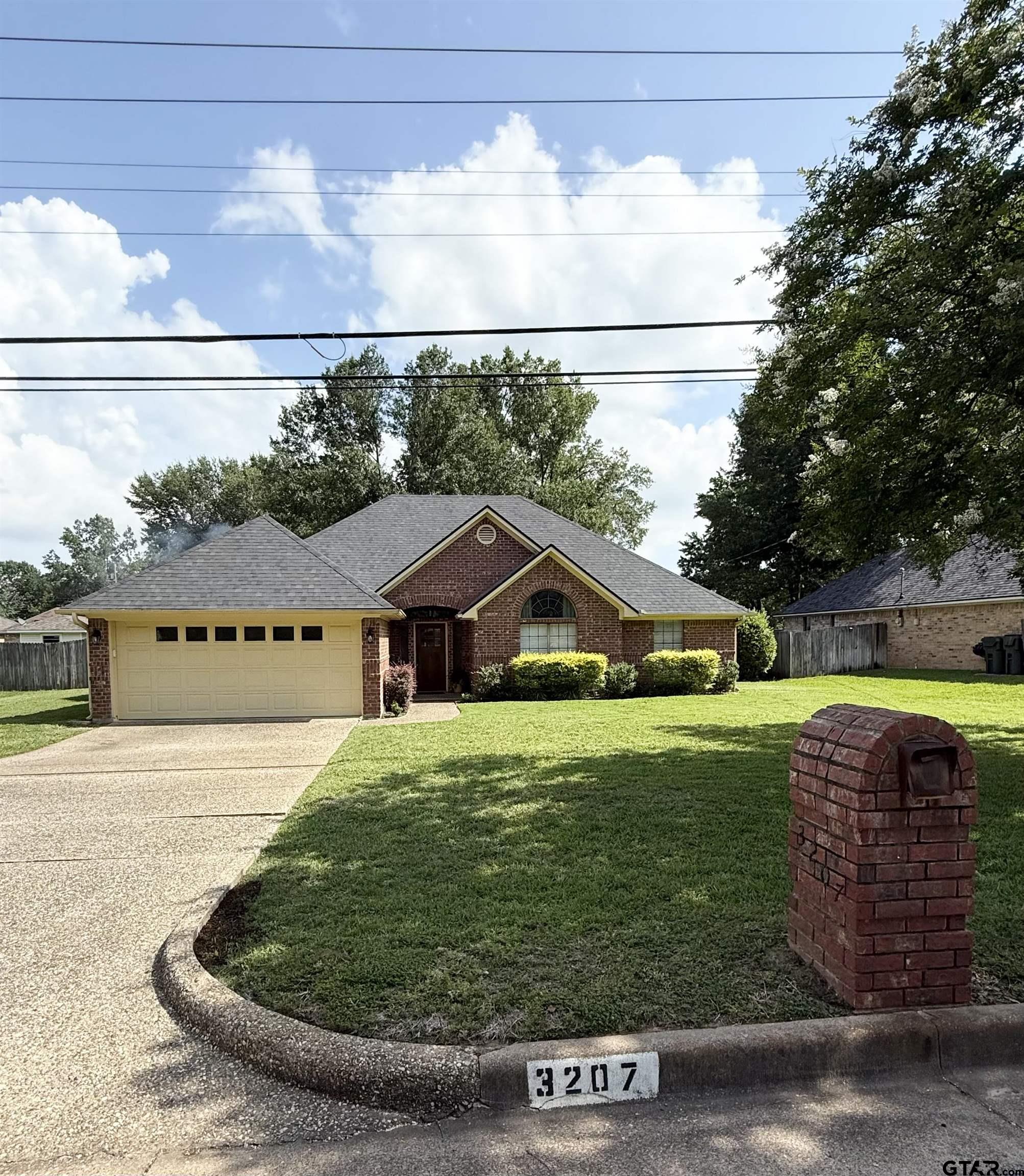 3207 McDonald Road Tyler, TX 75701 - Photo 1 of 24 a view of a house with a big yard potted plants and large trees