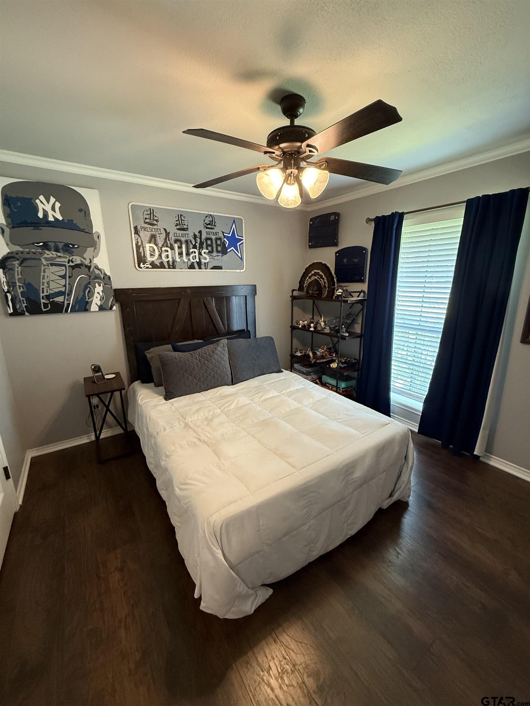 3207 McDonald Road Tyler, TX 75701 - Photo 15 of 24 a large bed sitting in a bedroom and a chandelier