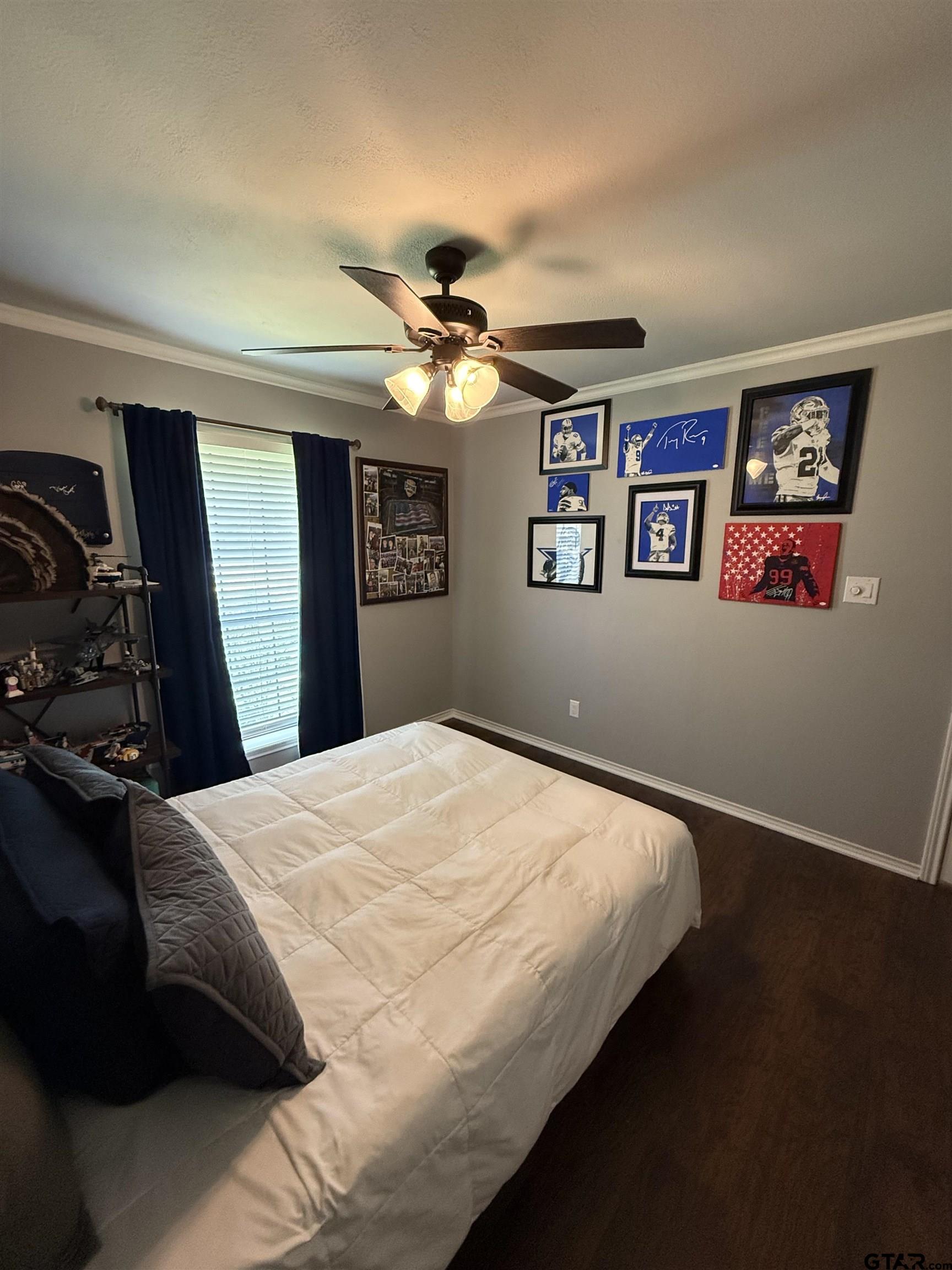 3207 McDonald Road Tyler, TX 75701 - Photo 16 of 24 a bedroom with a bed and a chandelier