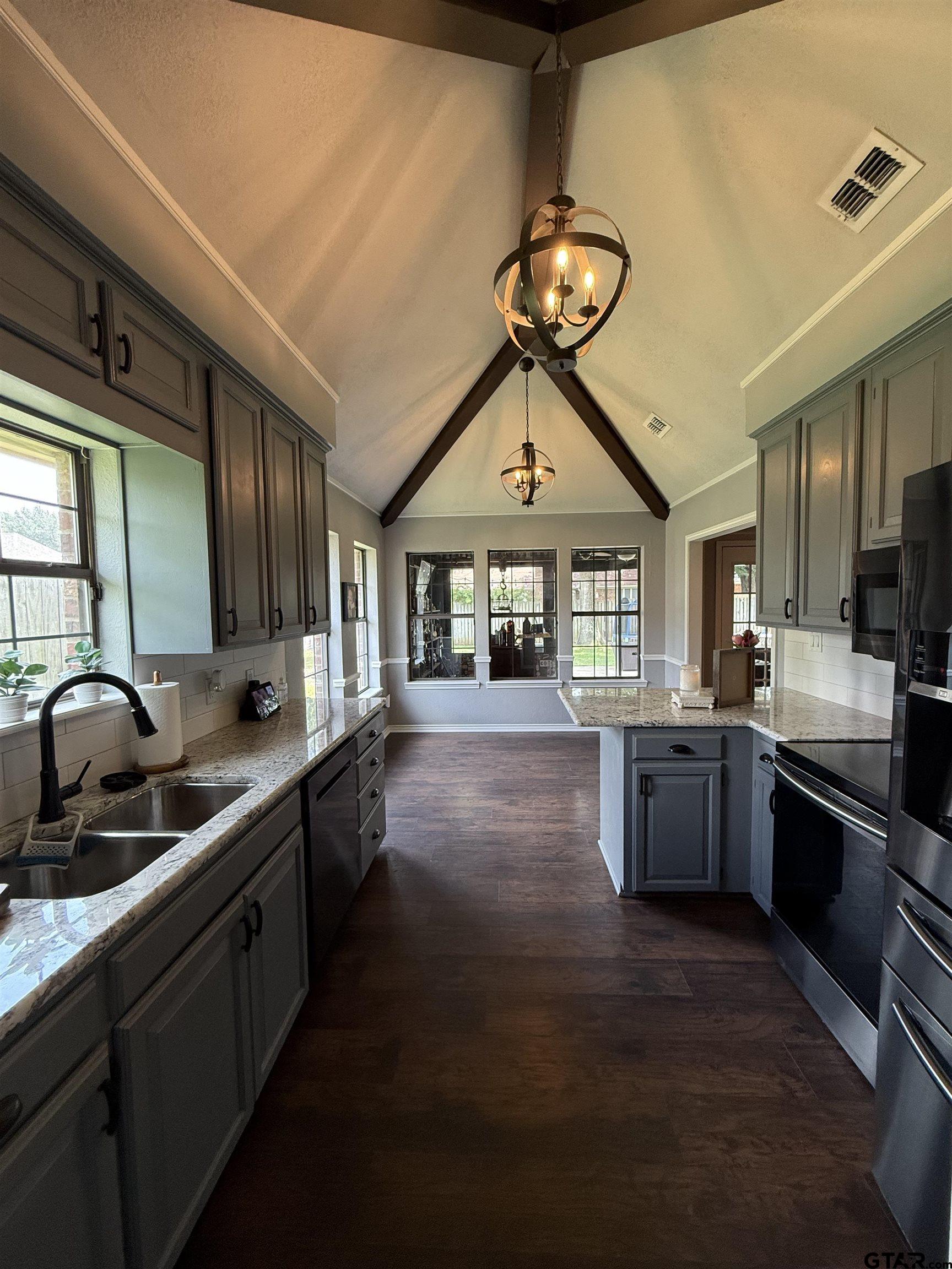 3207 McDonald Road Tyler, TX 75701 - Photo 7 of 24 a kitchen with kitchen island granite countertop a sink and a stove