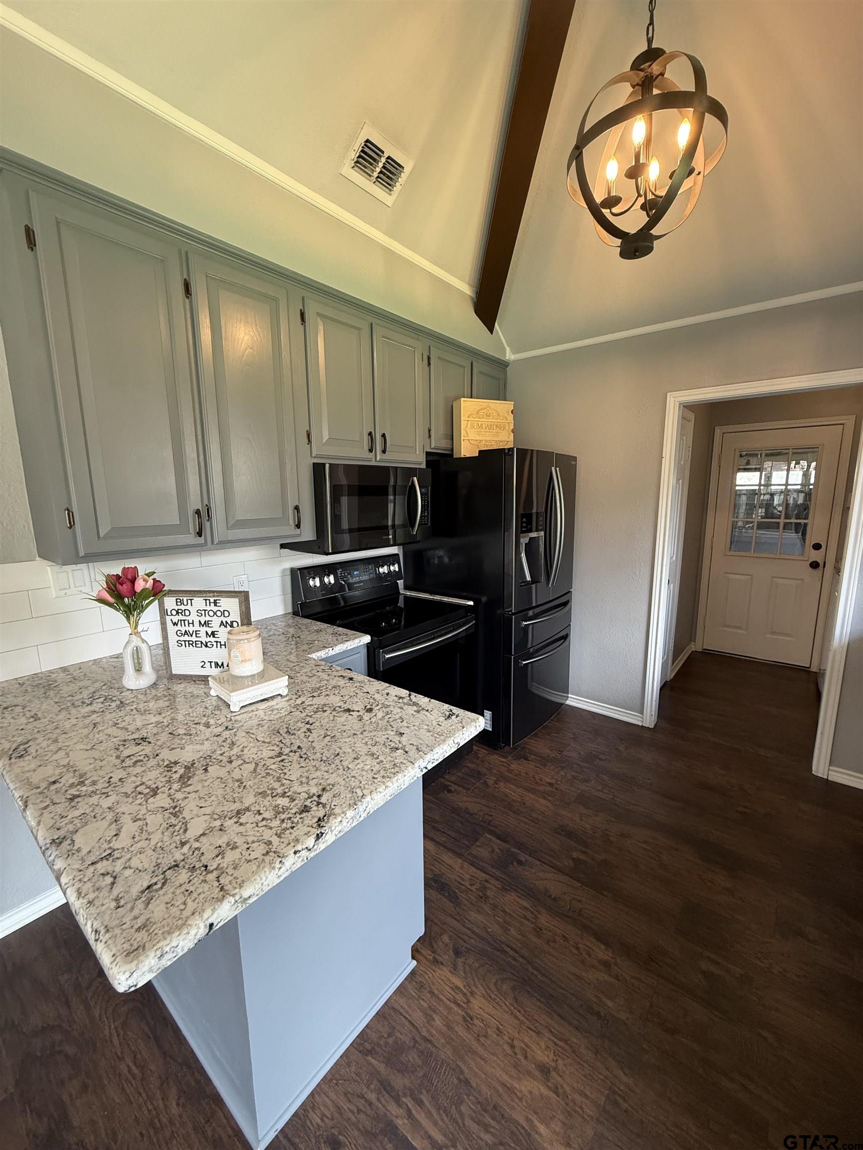 3207 McDonald Road Tyler, TX 75701 - Photo 8 of 24 a kitchen with stainless steel appliances granite countertop a sink refrigerator and microwave
