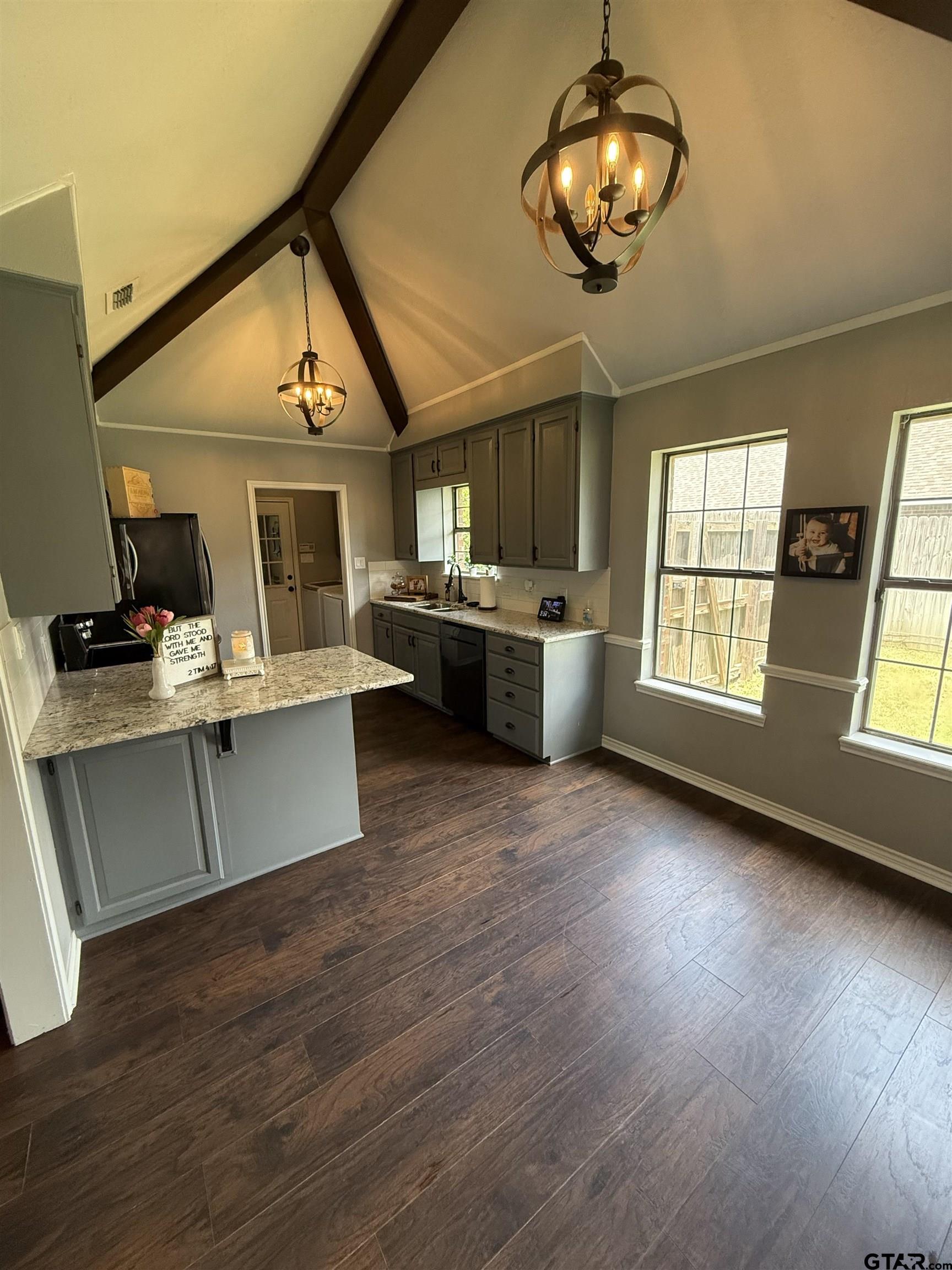 3207 McDonald Road Tyler, TX 75701 - Photo 10 of 24 a view of a dining room with furniture a chandelier and wooden floor