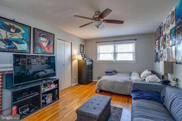 a bedroom with furniture and a flat screen tv