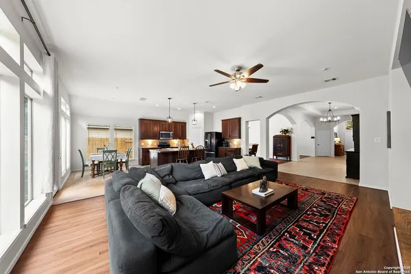 a living room with furniture a rug and a chandelier