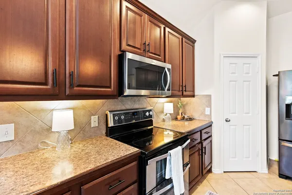 a kitchen with stainless steel appliances granite countertop a sink stove and microwave
