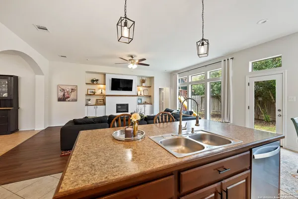 a view of a dining room and kitchen with a table chairs