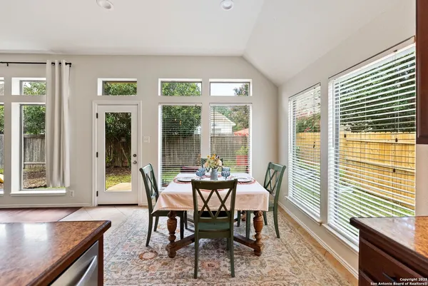 a dining room with furniture wooden floor and a rug