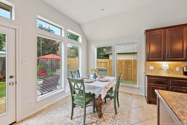 a dining room with furniture and window