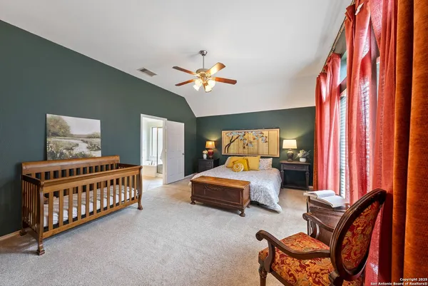 a bedroom with furniture and a chandelier