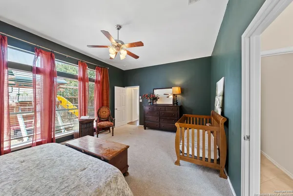 a bedroom with furniture and large windows