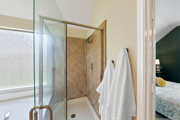a bathroom with a shower and a tub