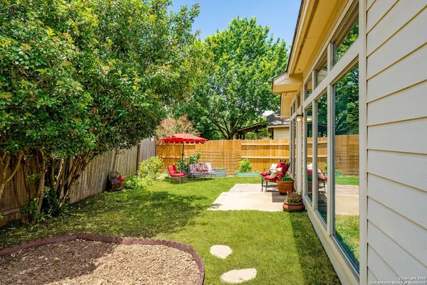 a view of a backyard with a garden and trees