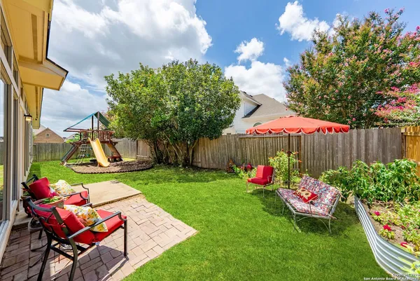 a backyard of a house with table and chairs