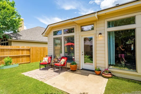 a view of a lounge chair in the patio next to a yard