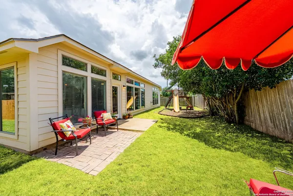 a backyard of a house with table and chairs