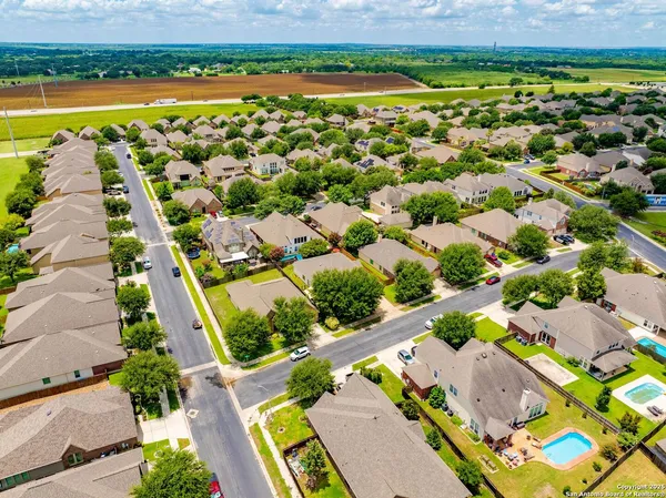 an aerial view of residential houses with outdoor space