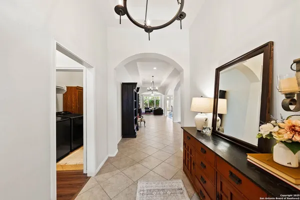 a view of a hallway with mirror and window