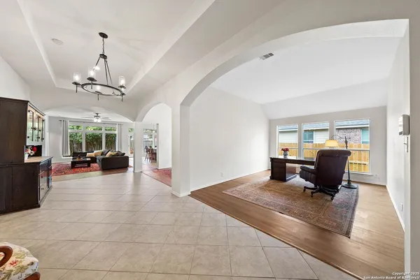 a living room with furniture and a chandelier