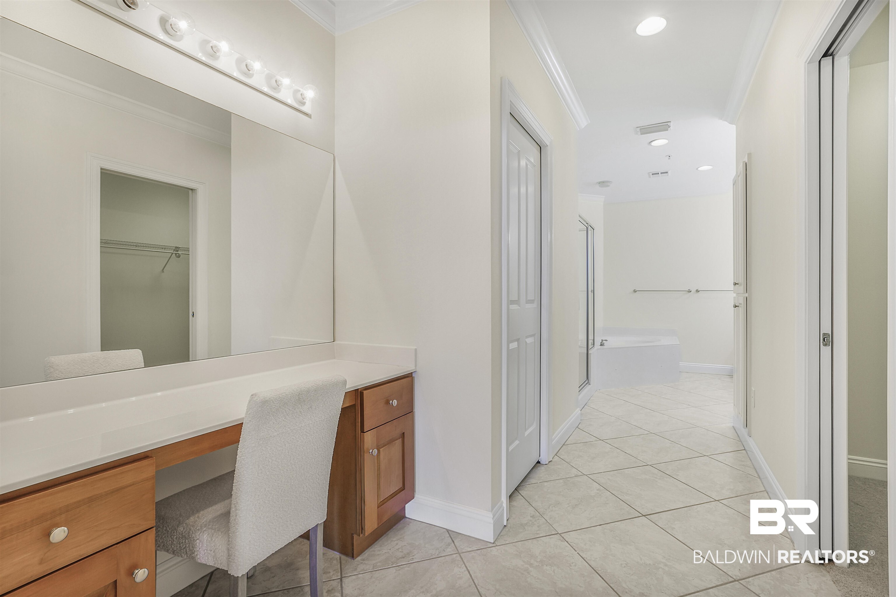 28250 Canal Road, Unit 106 Orange Beach, AL 36561 - Photo 13 of 50 Full bath featuring light tile patterned flooring, a shower stall, a garden tub, ornamental molding, and a spacious closet